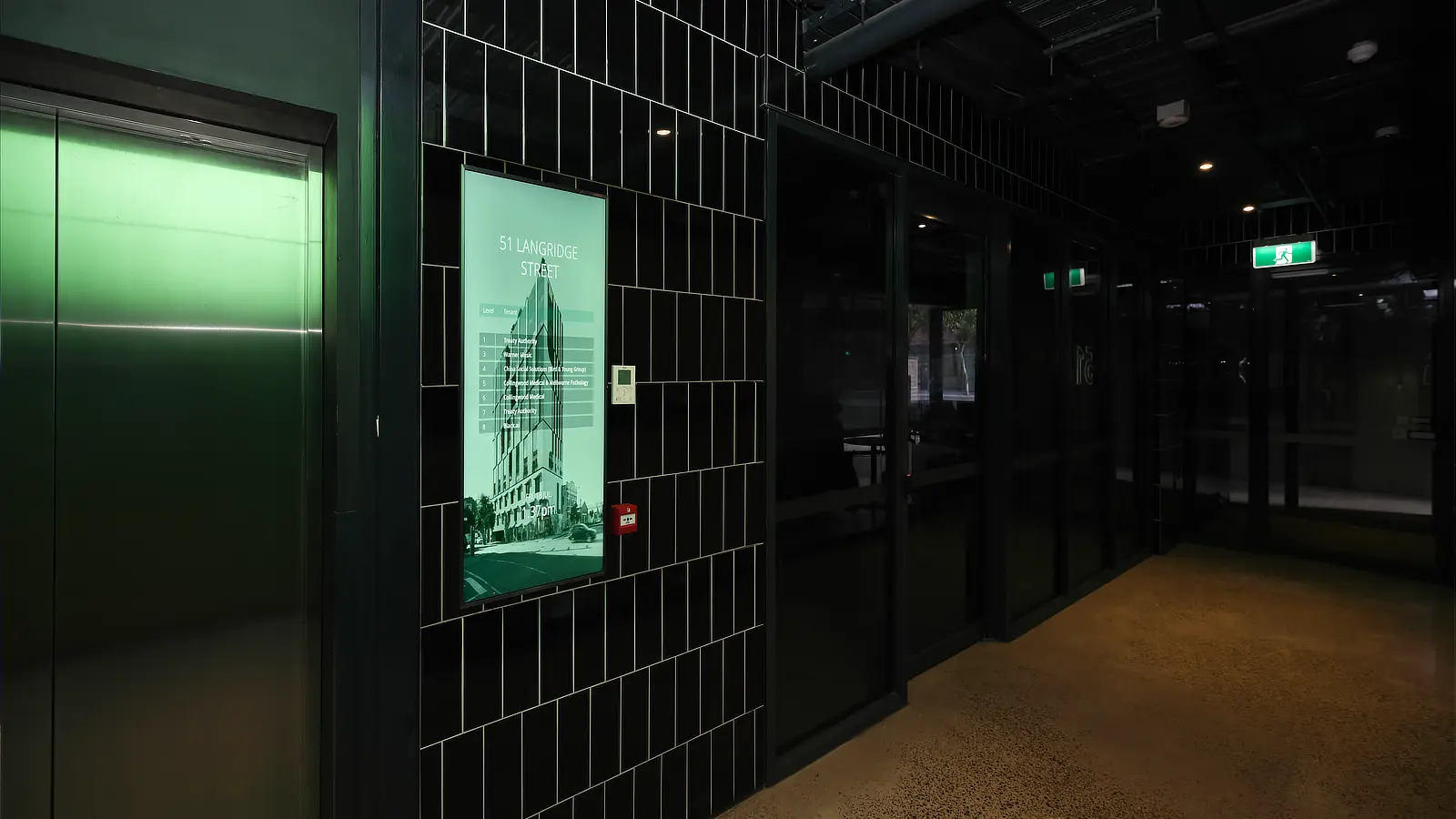 Streamline Series Digital Tenant Directory in the tiled corridor lift lobby of 51 Langridge Street Collingwood.