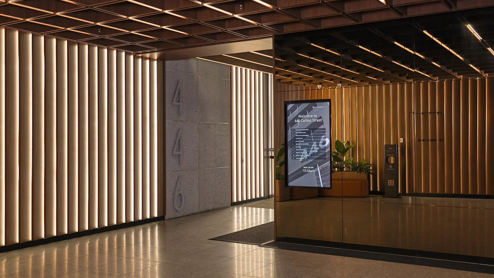 Recessed Wall Mounted Digital Directory set into glass wall at 446 Collins Street