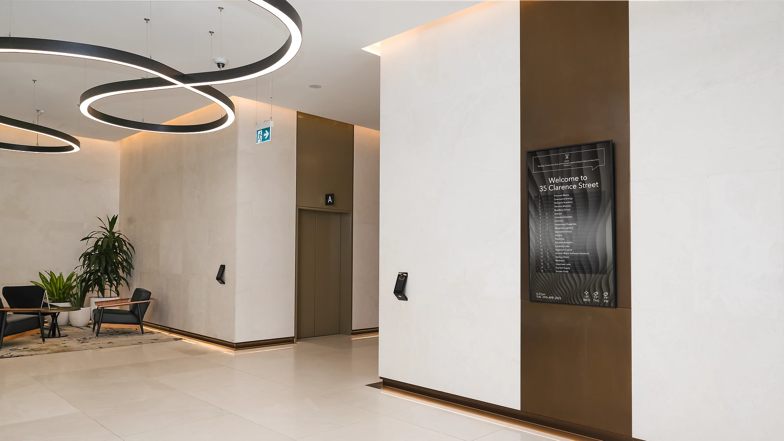 Streamline Series Digital Tenant Directory near the modern lift lobby of 35 Clarence Street Sydney. Chairs and custom lighting design feature prominently